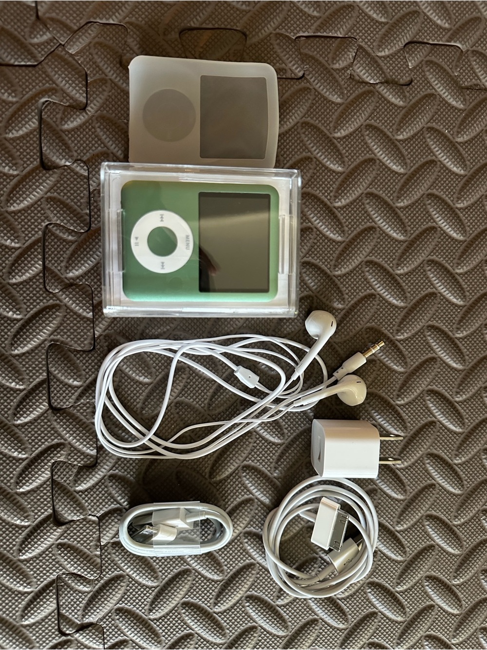Apple Green iPod Nano with White Earbuds and Charging Accessories